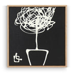 Framed black and white abstract artwork of a plant on a plain background